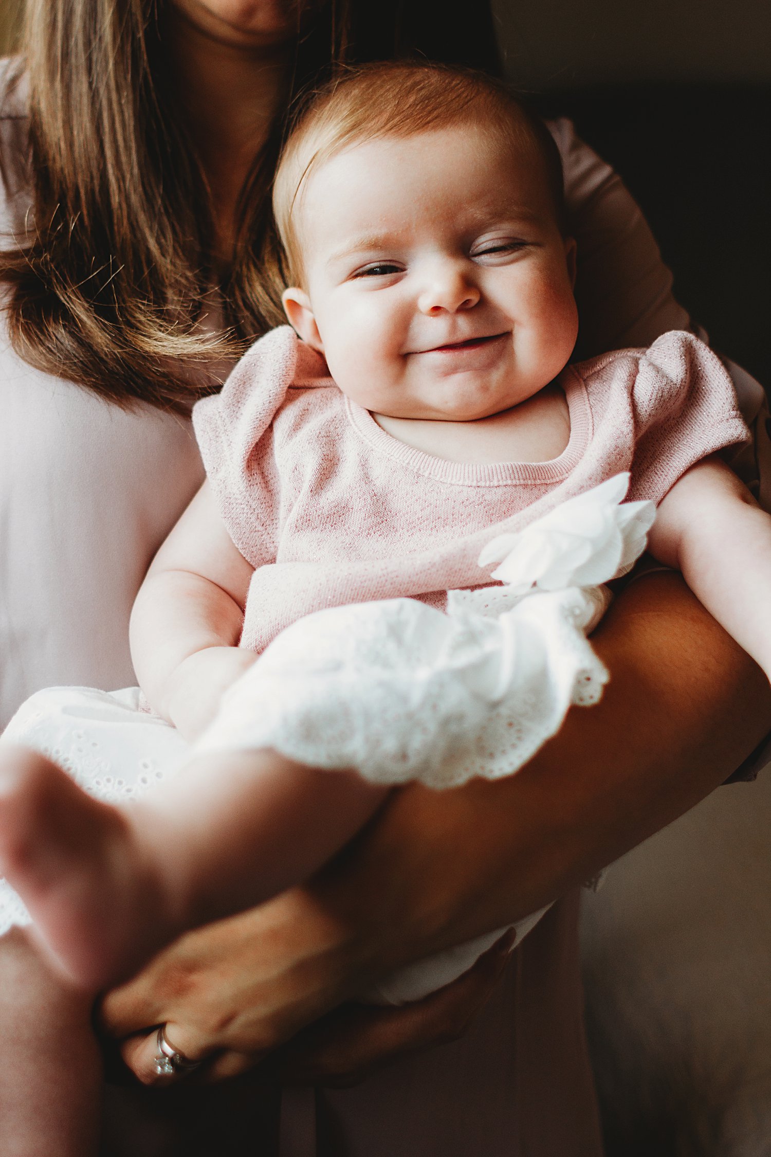 Portrait of baby girl in mom's arms