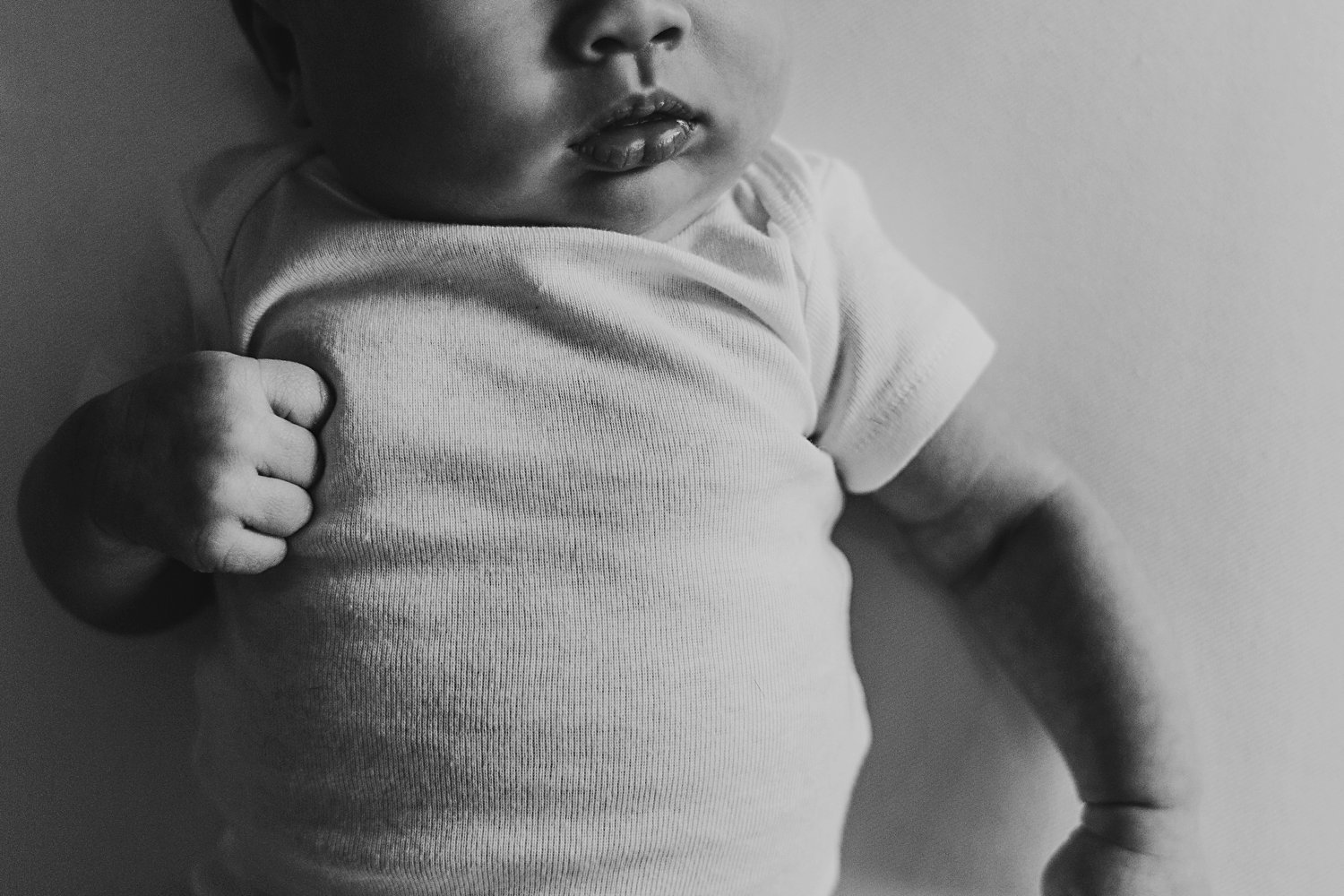 Newborn baby's hand and face details