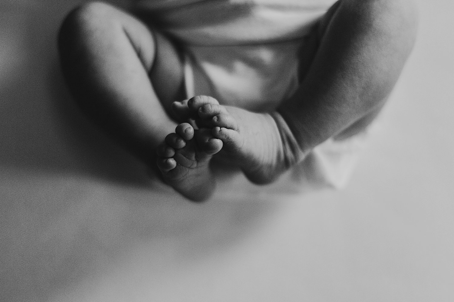 Newborn baby feet curled up