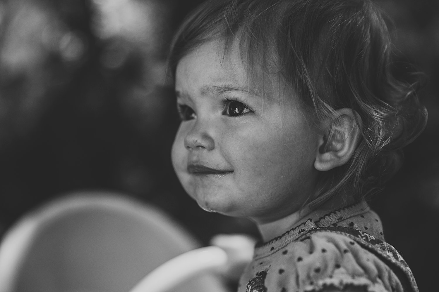 Toddler girl pushing toy stroller