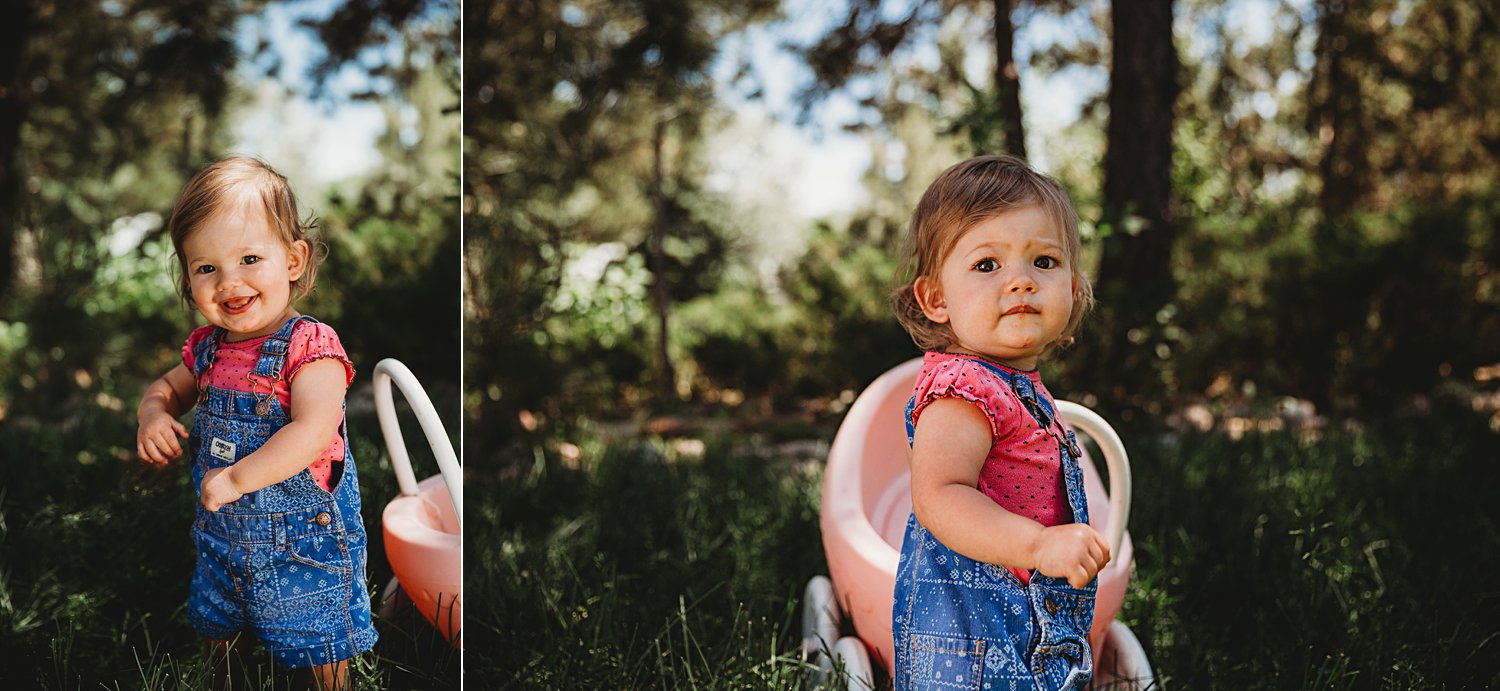 Toddler girl pushing toy stroller