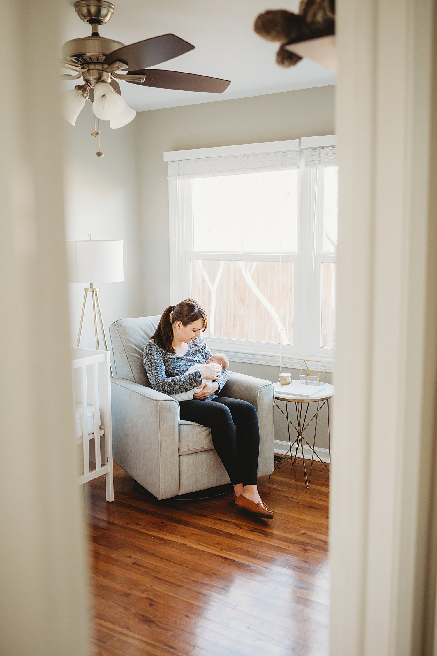 Candid lifestyle family photo of mom holding newborn baby