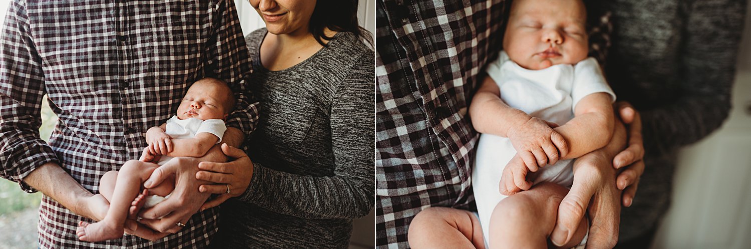 Lifestyle family portraits of parents holding newborn baby