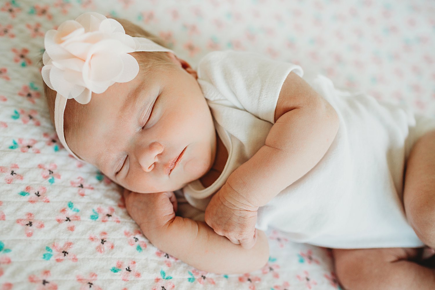 Baby asleep in crib with hand under cheek