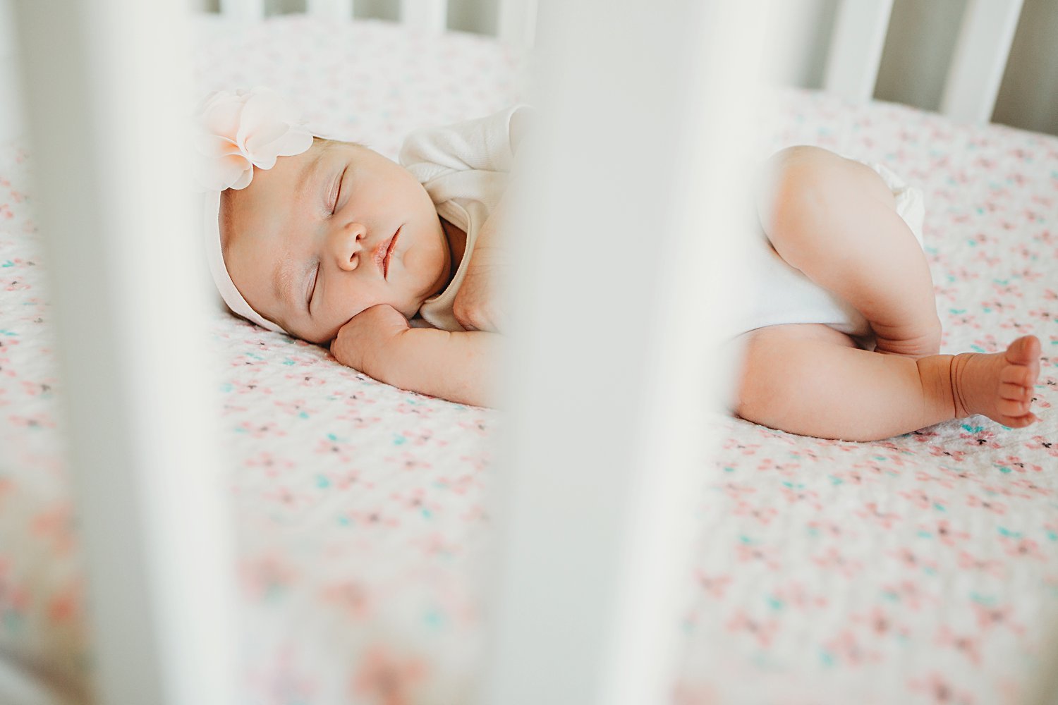 Newborn baby asleep in crib