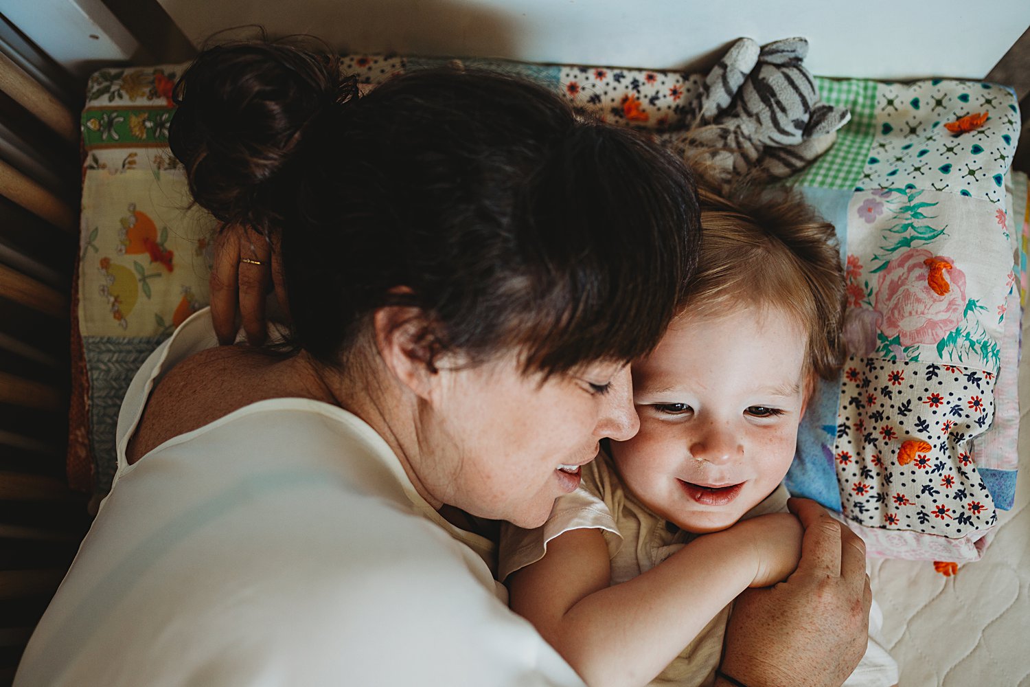 Mom and son snuggling in bed