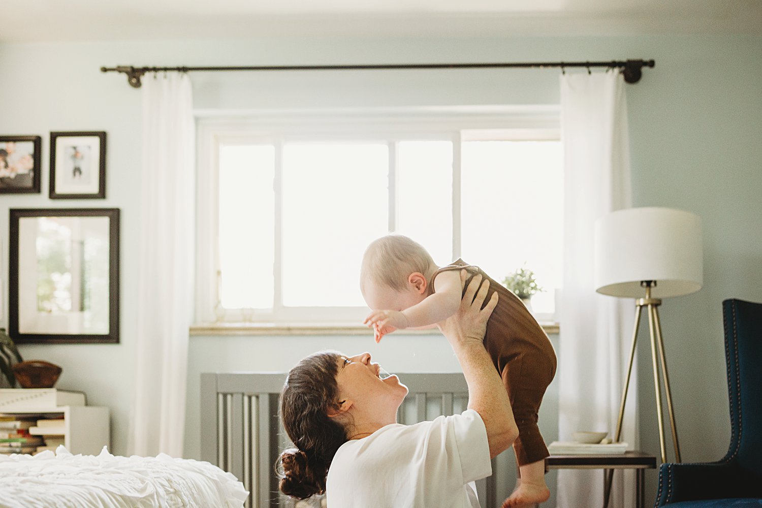 Mom holding baby boy above her head